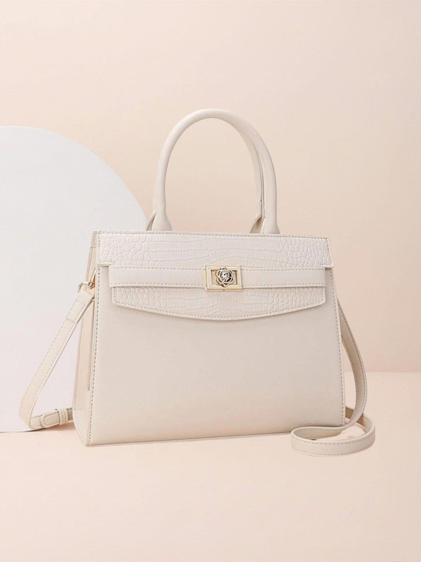 Beige handbag with a gold clasp on a beige background