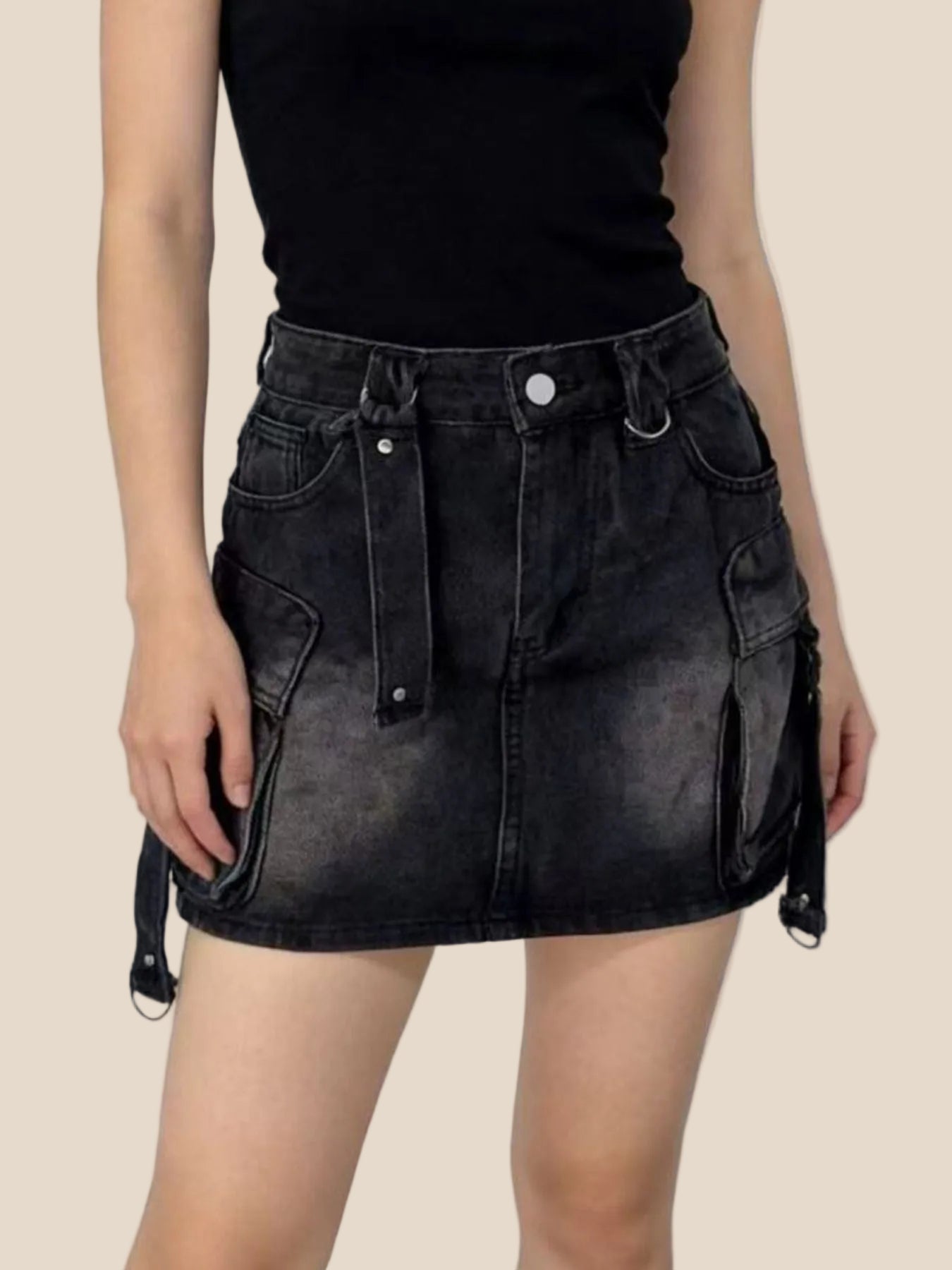 Black denim skirt worn by a person on a white background