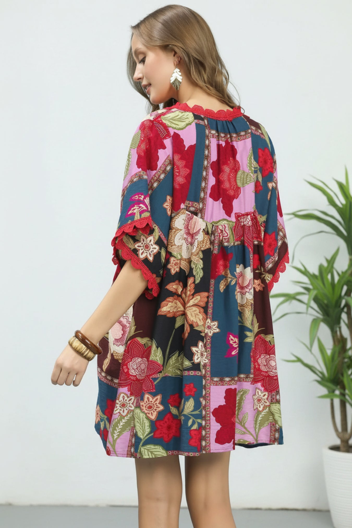 Woman wearing a colorful floral dress on a white background
