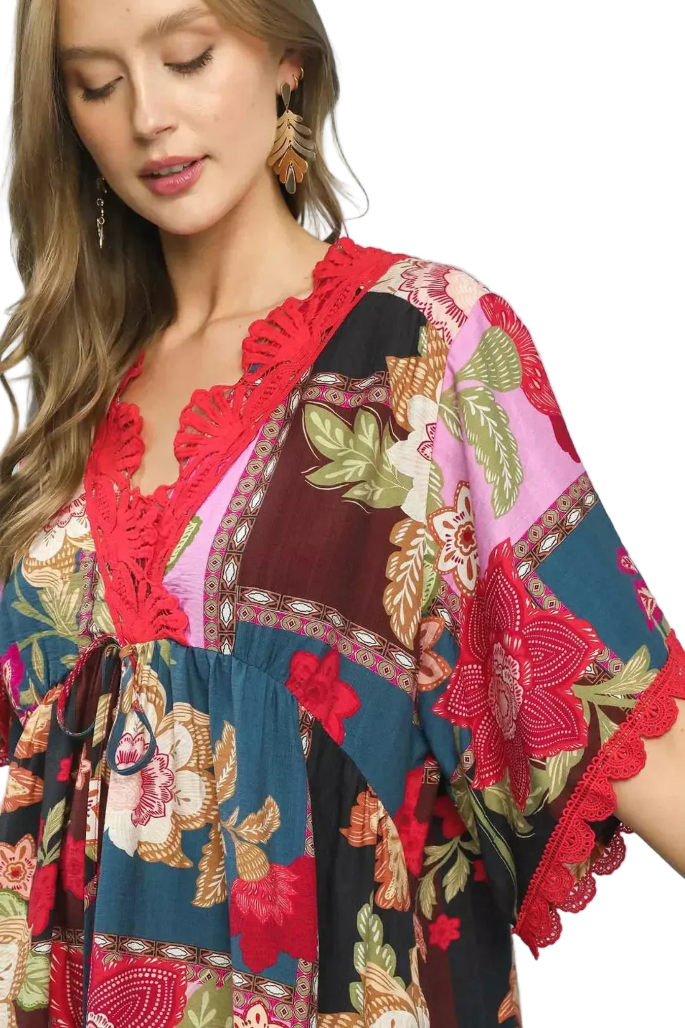 Woman wearing a colorful patterned dress with a white background