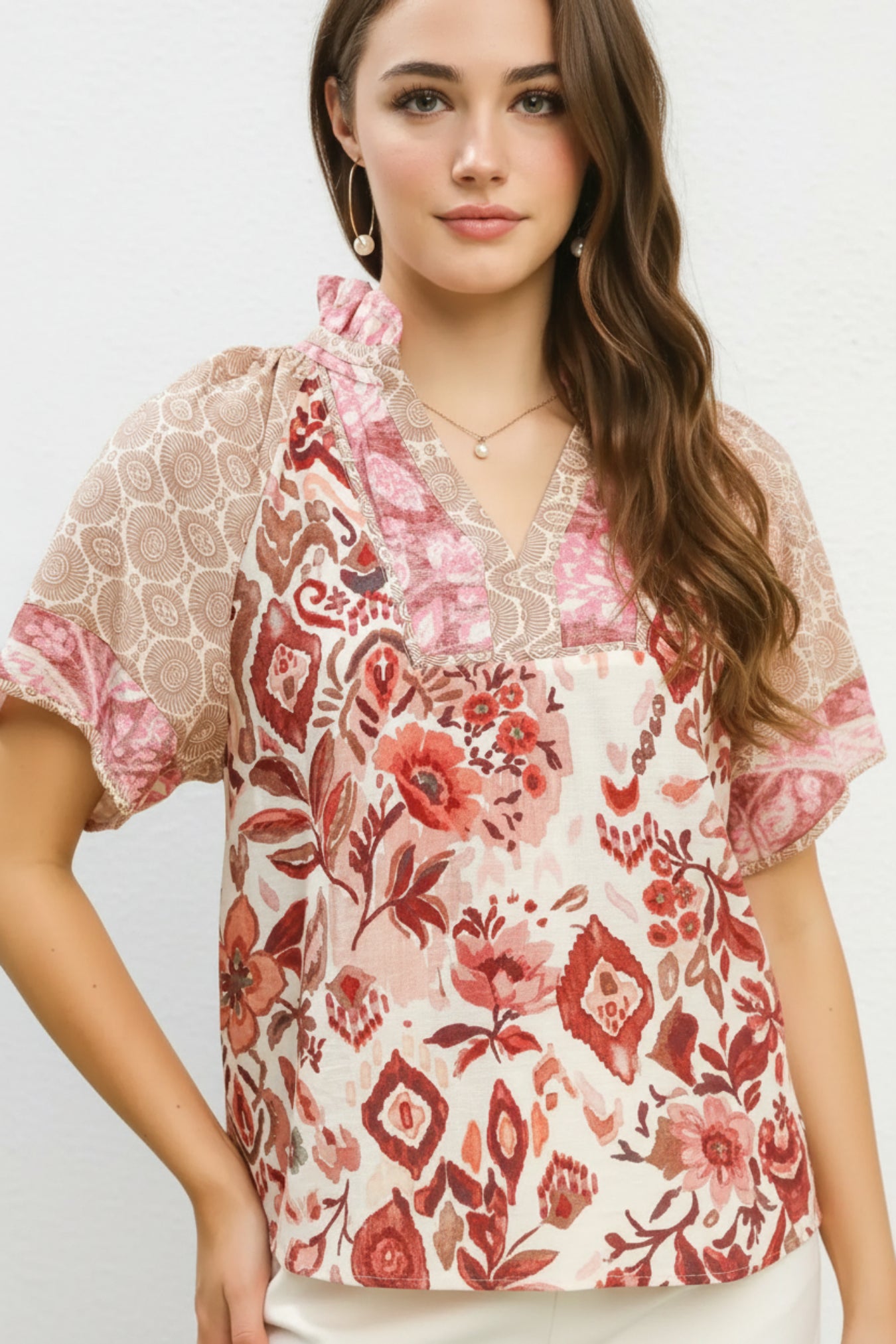 Woman wearing a floral blouse with a white background