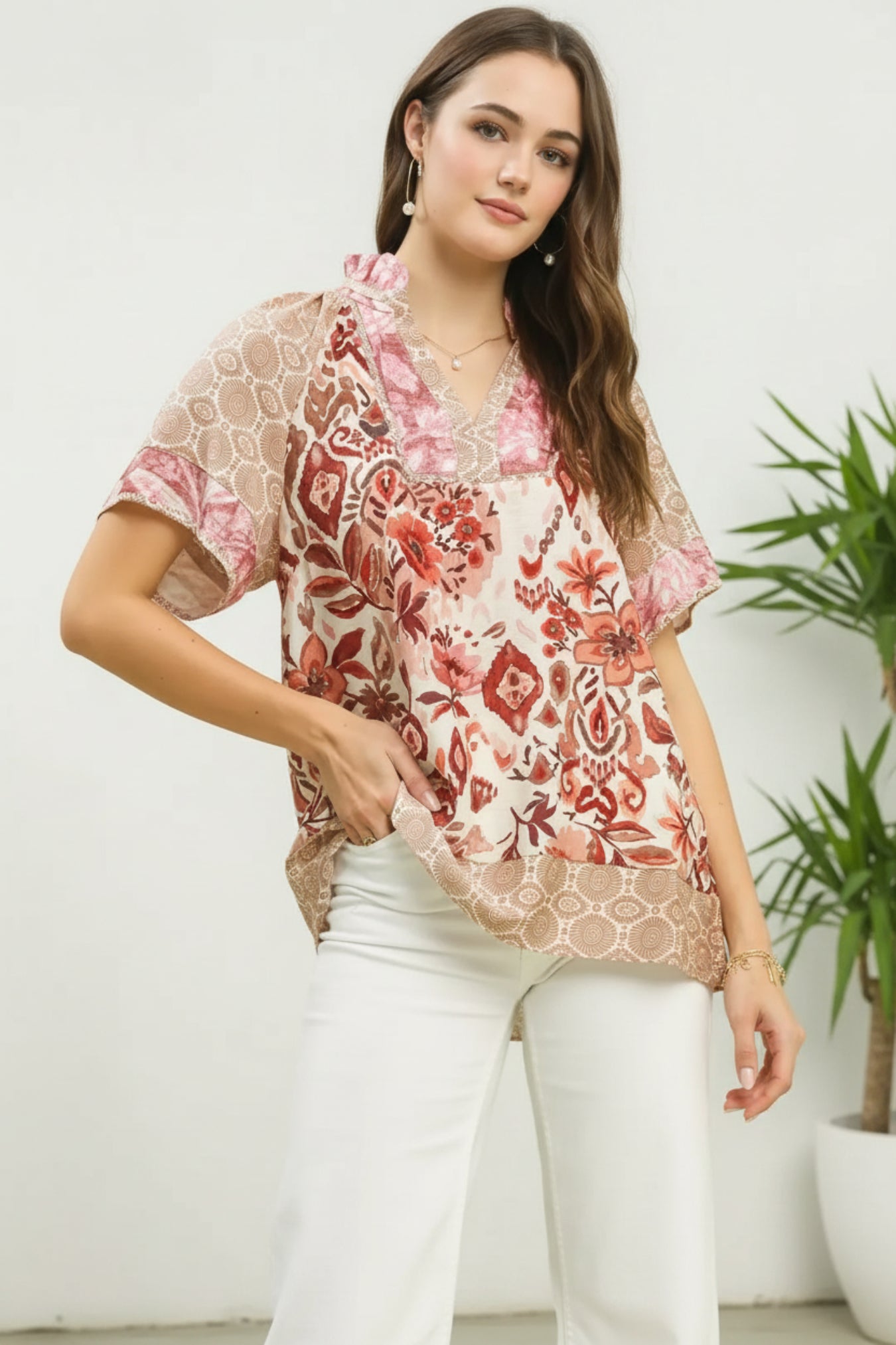 Woman wearing a floral blouse with a white background