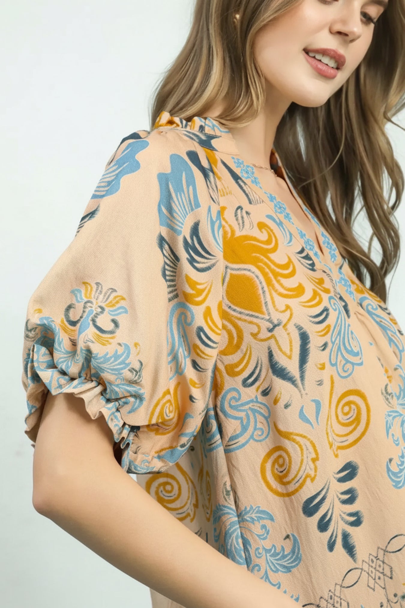 Woman wearing a floral blouse with a white background