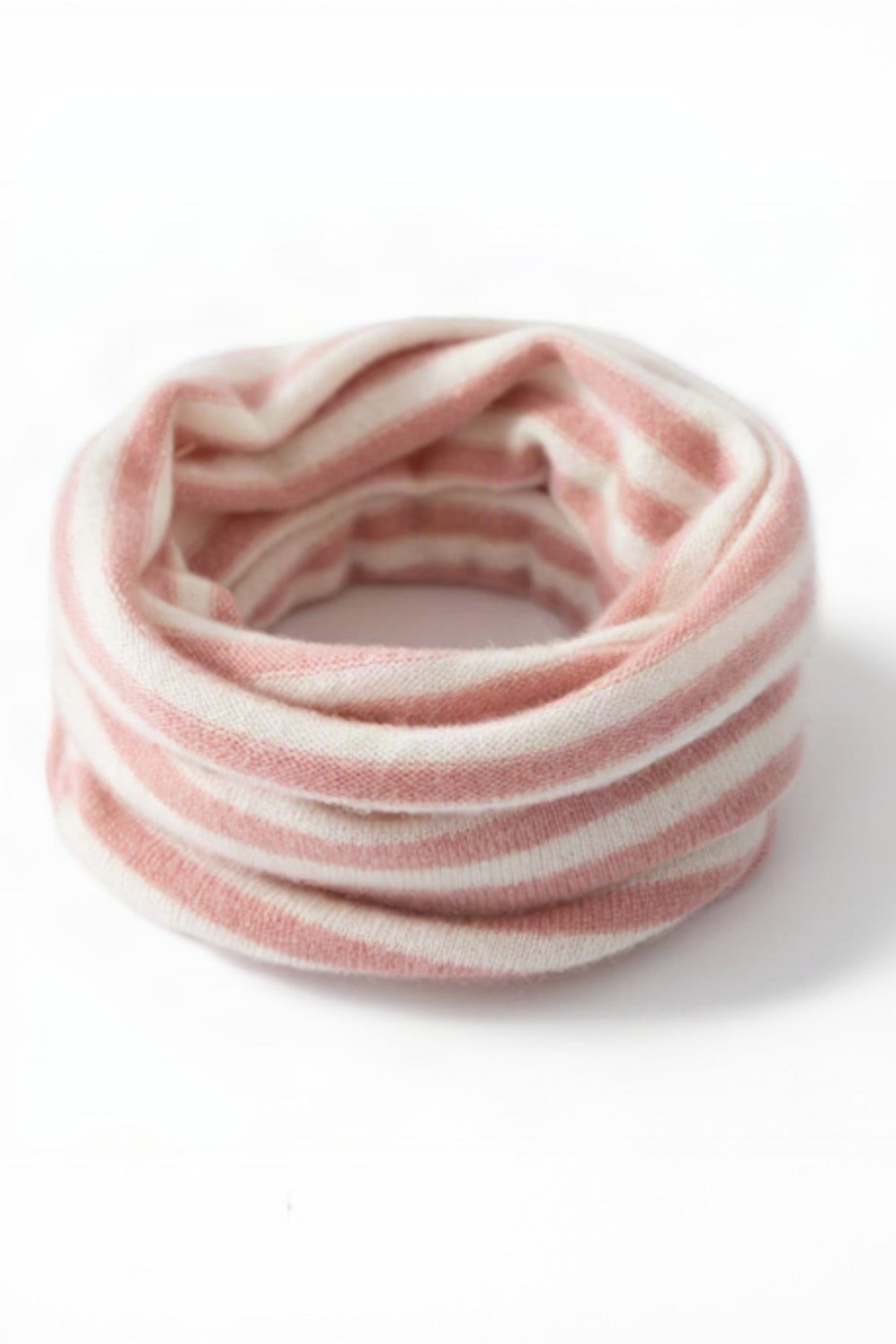 Pink and white striped fabric on a white background