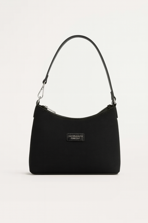 Black nylon adjustable strap crossbody bag with minimalist design and rectangular plaque