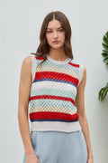 Woman wearing a colorful striped sleeveless sweater against a white background