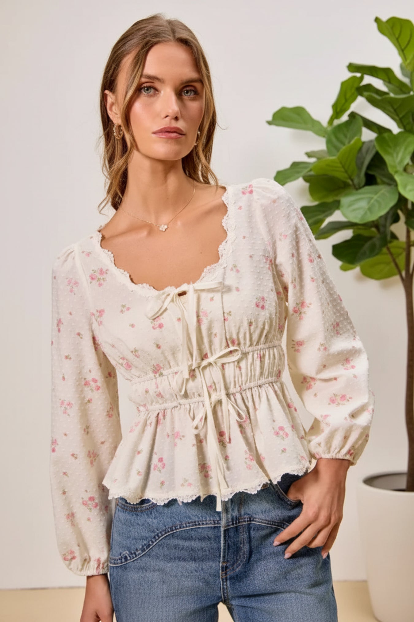 Woman wearing a floral blouse with a beige background