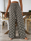 Person wearing patterned wide-leg pants in a casual setting.