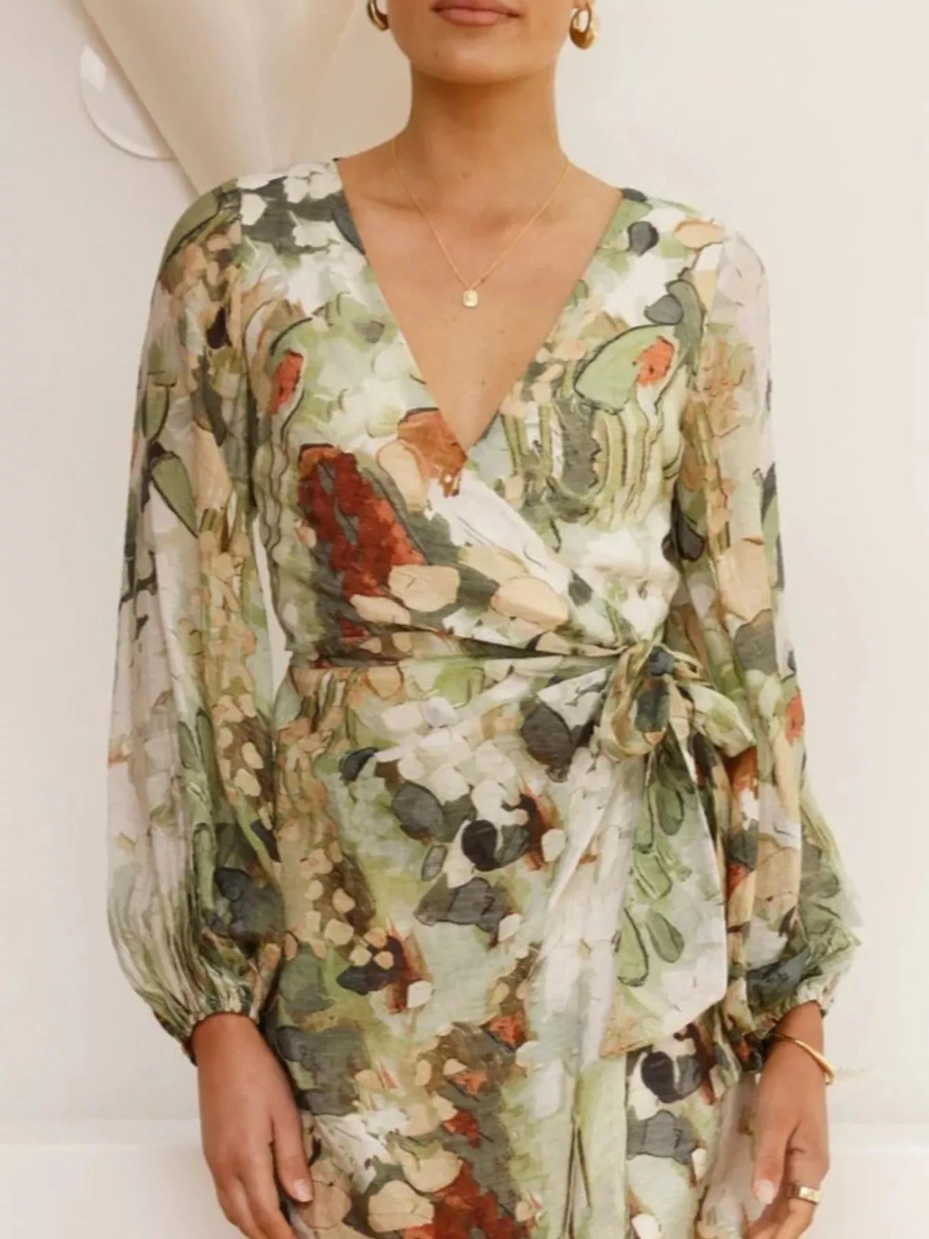 Woman wearing a floral dress with a neutral background