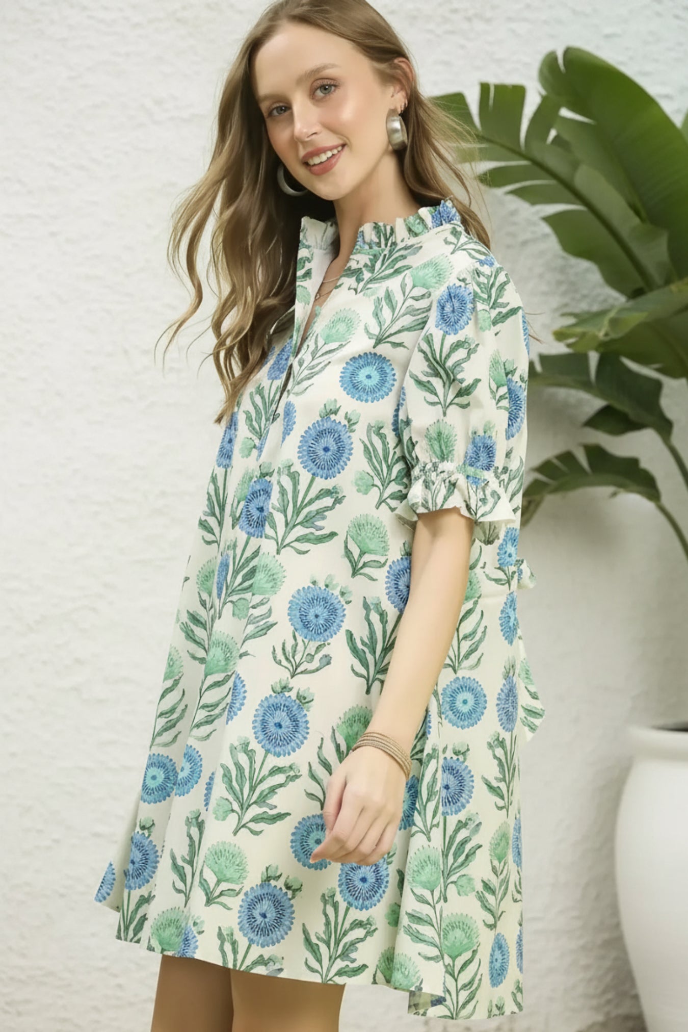 Woman wearing a floral dress with a green background