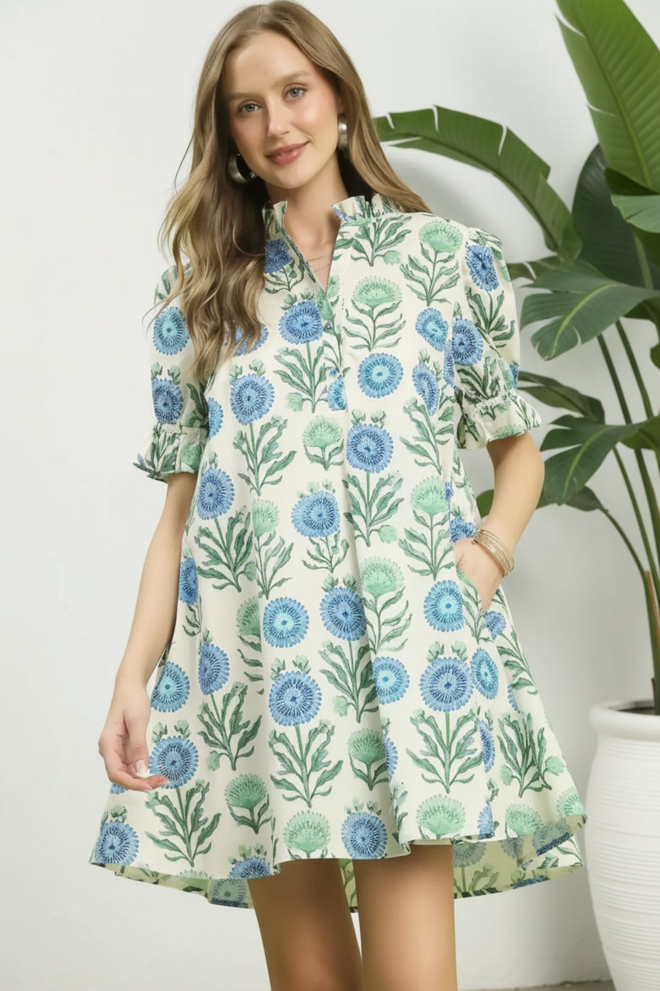 Woman wearing a floral dress on a light white background
