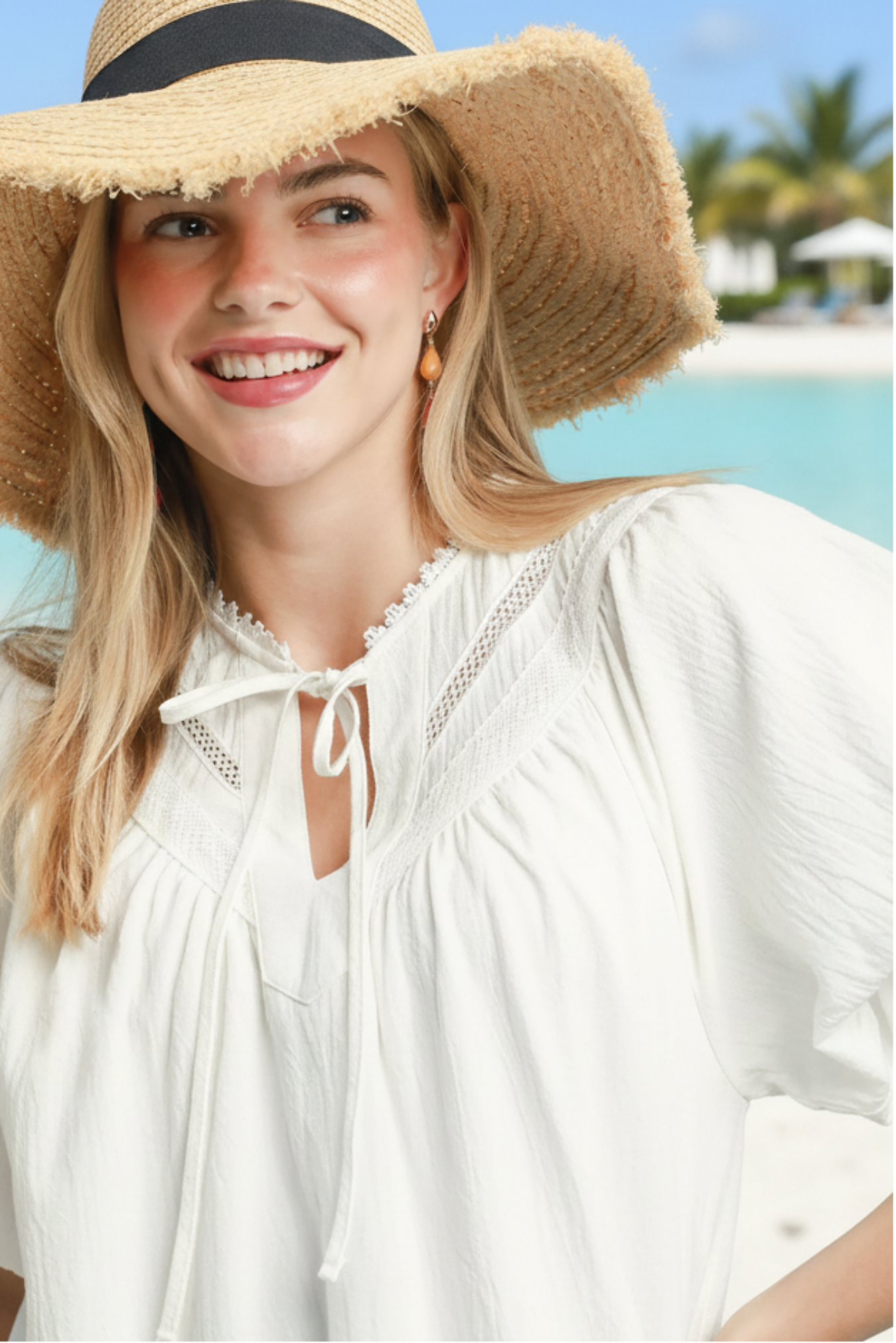 Woman wearing a white blouse and straw hat on a beach outdoor background