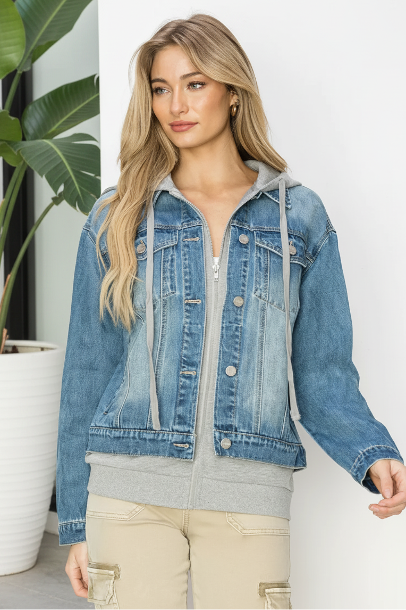 Woman wearing a blue denim jacket on a white background