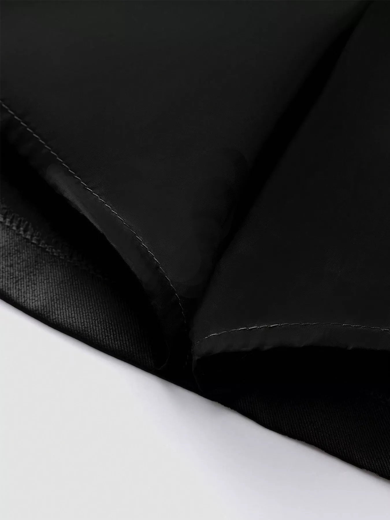 Close-up of black fabric texture on a white background