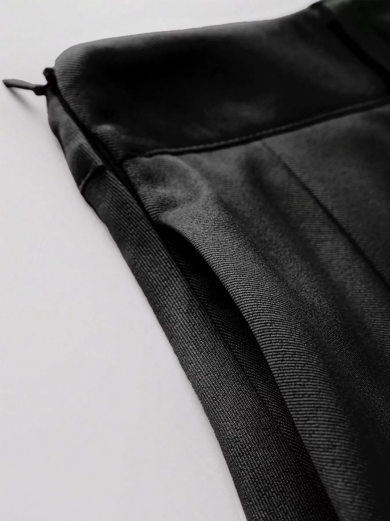 Close-up of a black textured fabric on a light gray background
