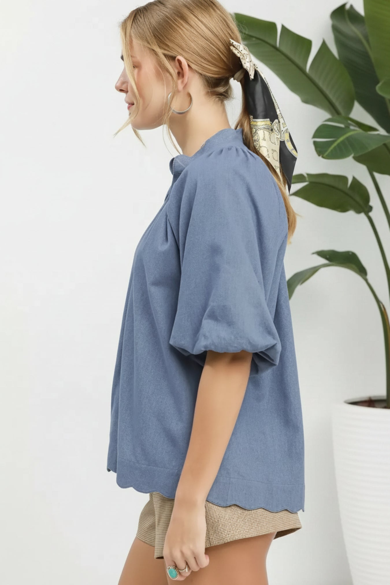 Woman wearing a denim shirt on a white background