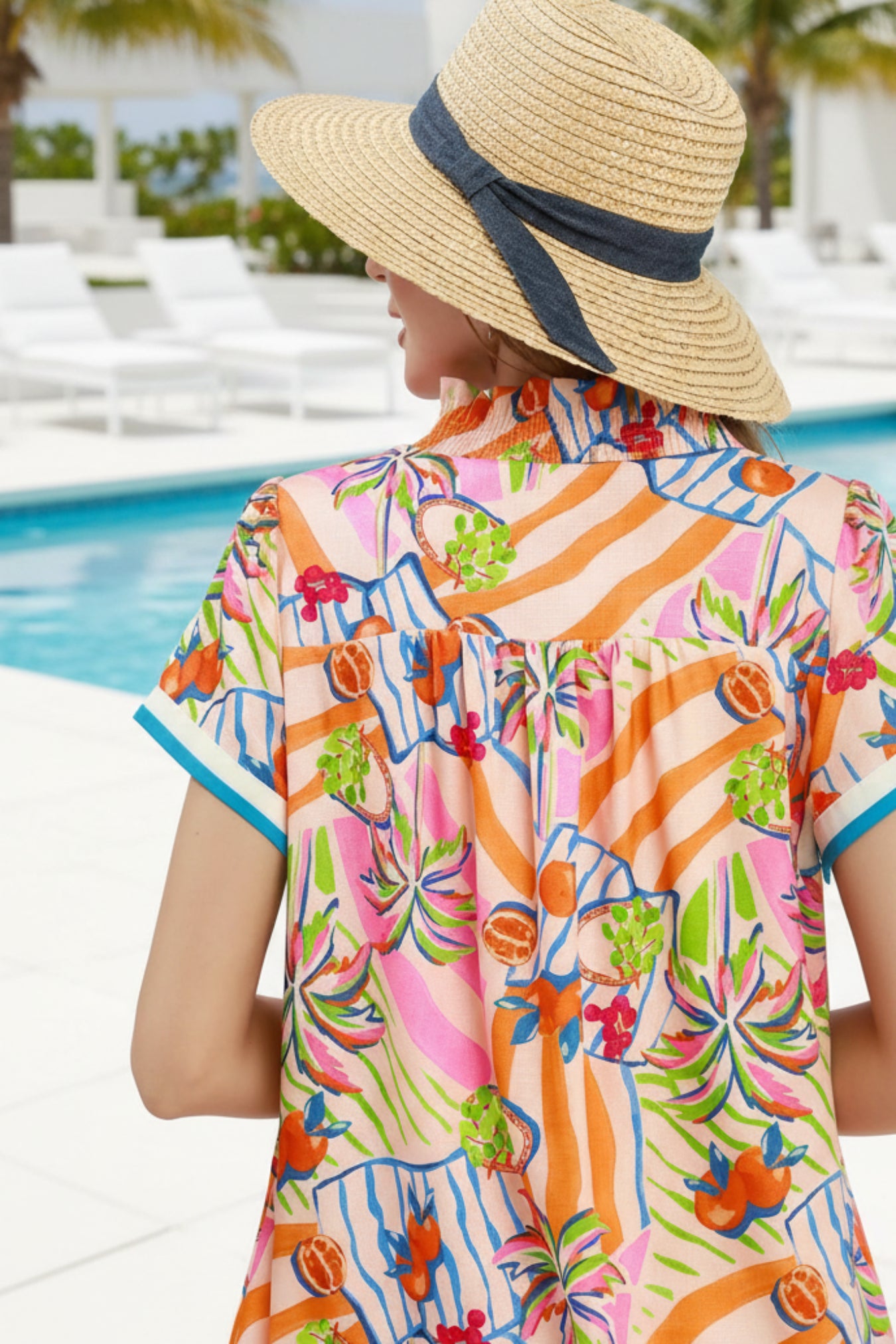 Colorful patterned shirt with a straw hat on a pool outdoor background