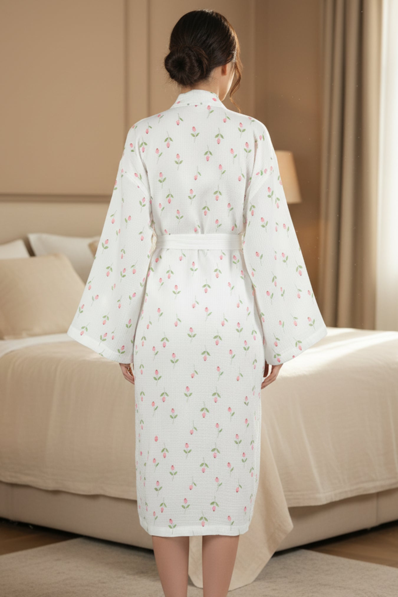 Woman wearing a white floral robe in a bedroom setting