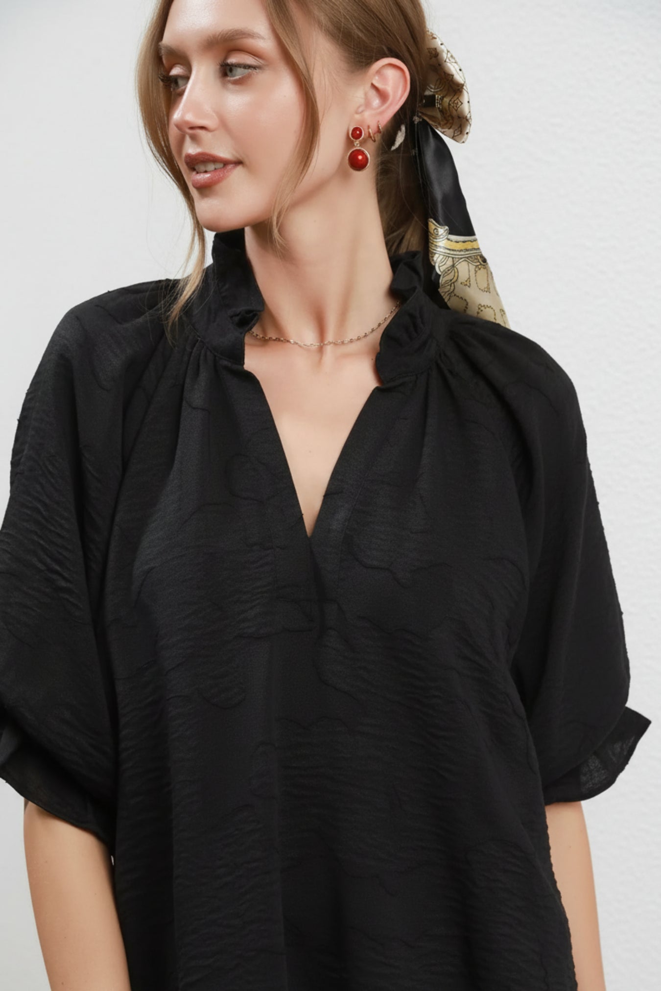 Woman wearing a black blouse with a white background