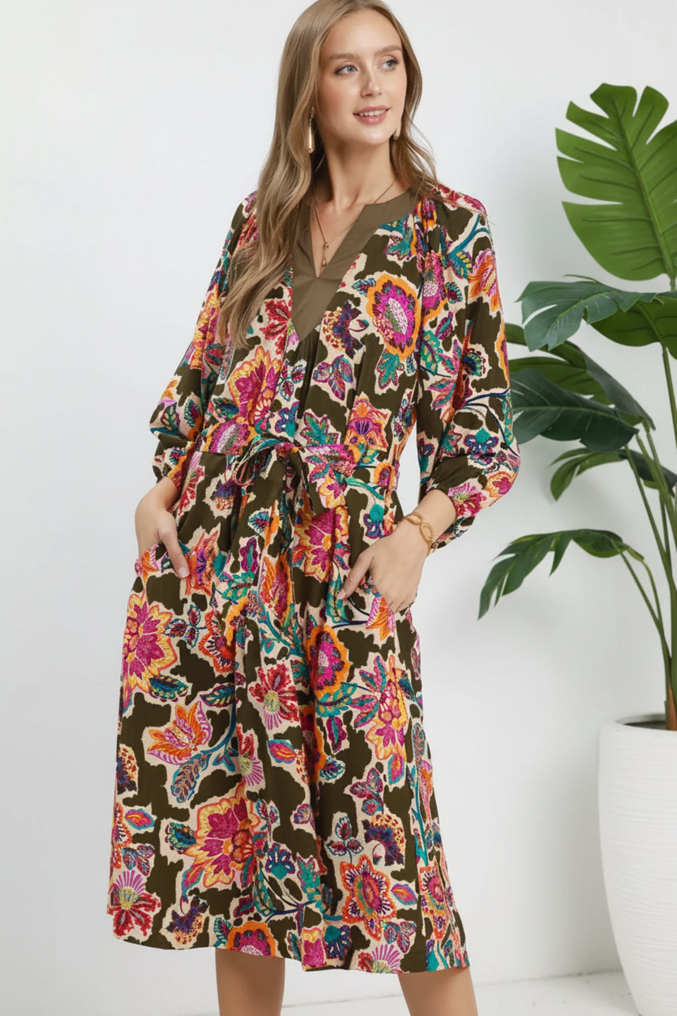 Woman wearing a colorful floral dress on a white background