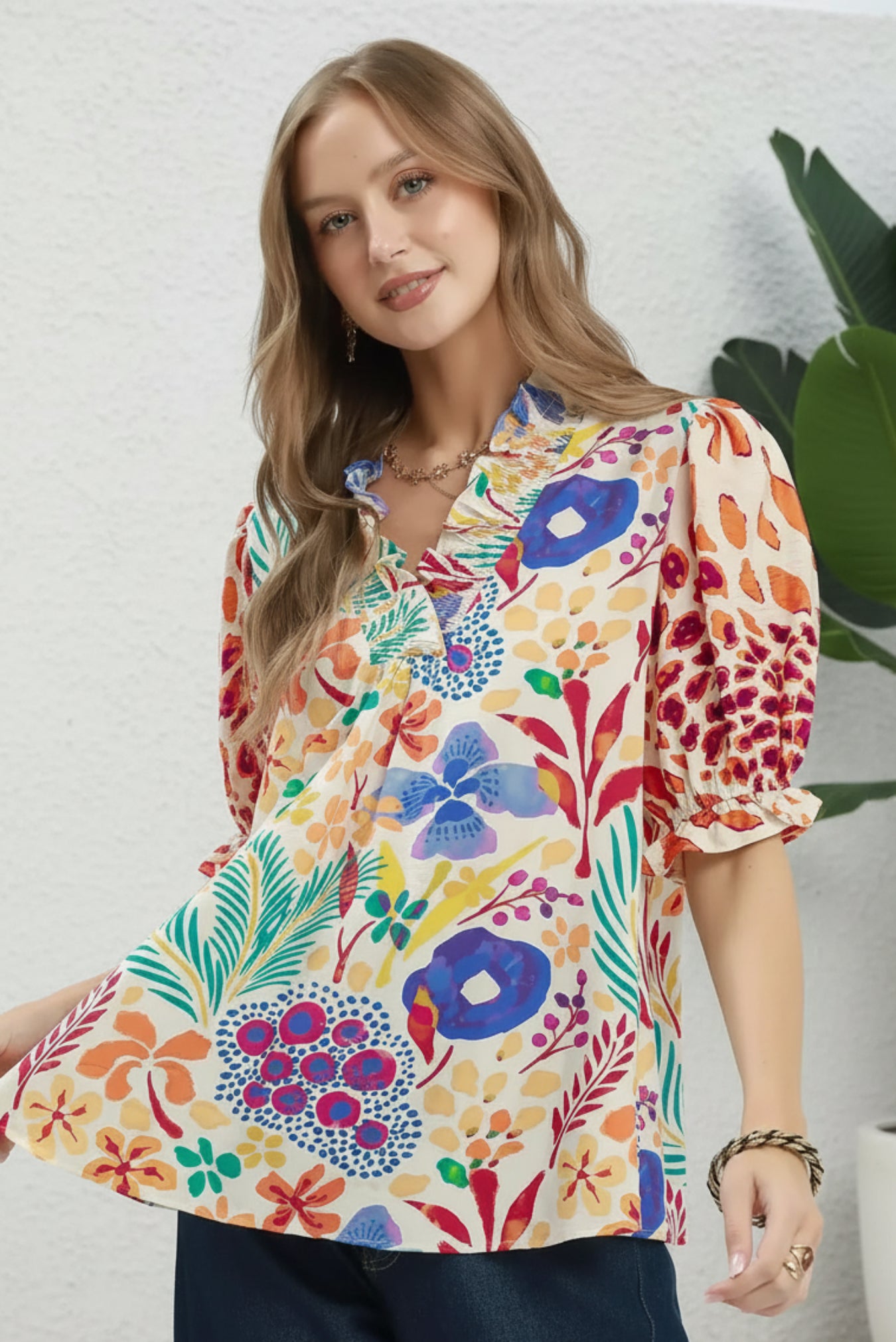 Woman wearing a colorful floral blouse on a white background