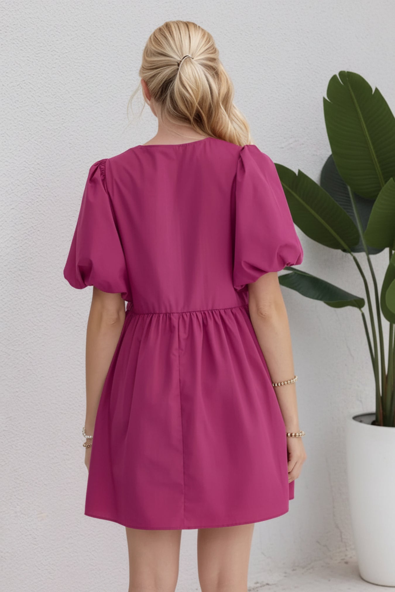 Woman wearing a pink dress against a white background