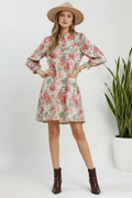 Woman wearing a floral dress with long sleeves and a hat on a white background