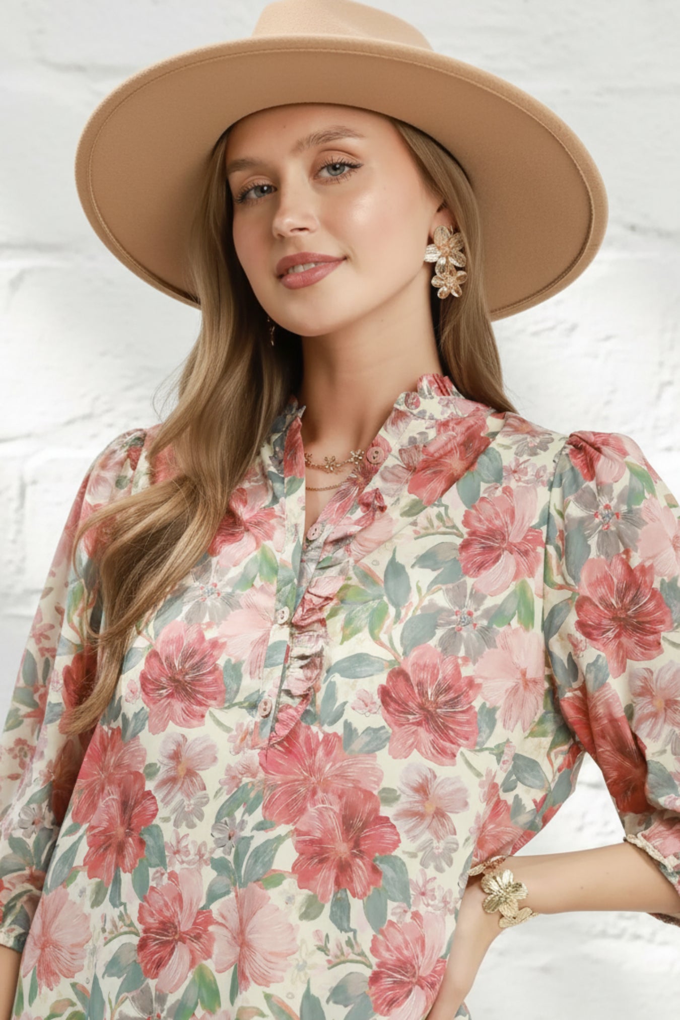 Woman wearing a floral blouse with a rust mix pattern on a white background