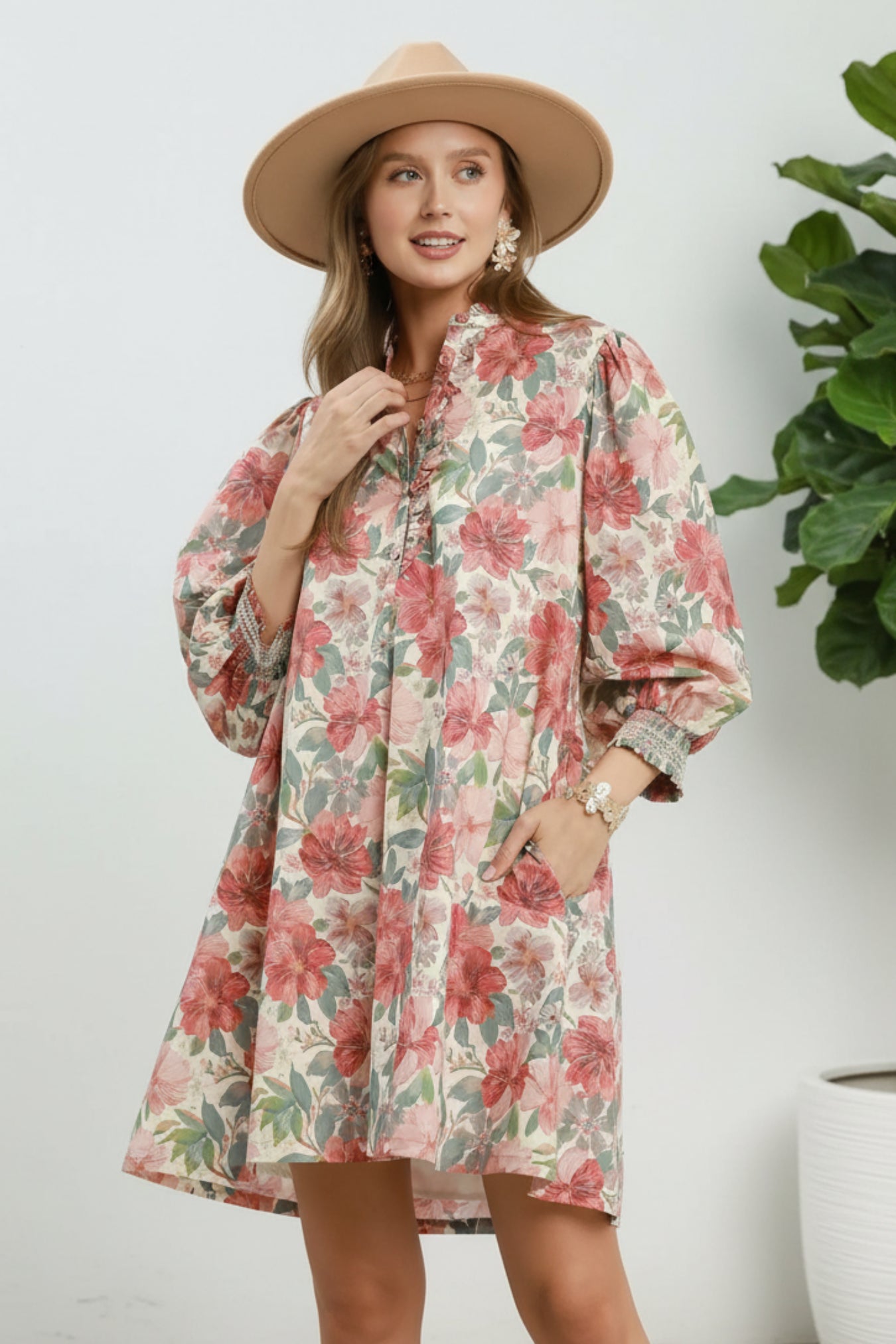 Woman wearing a floral dress with a rust mix color scheme on a white background