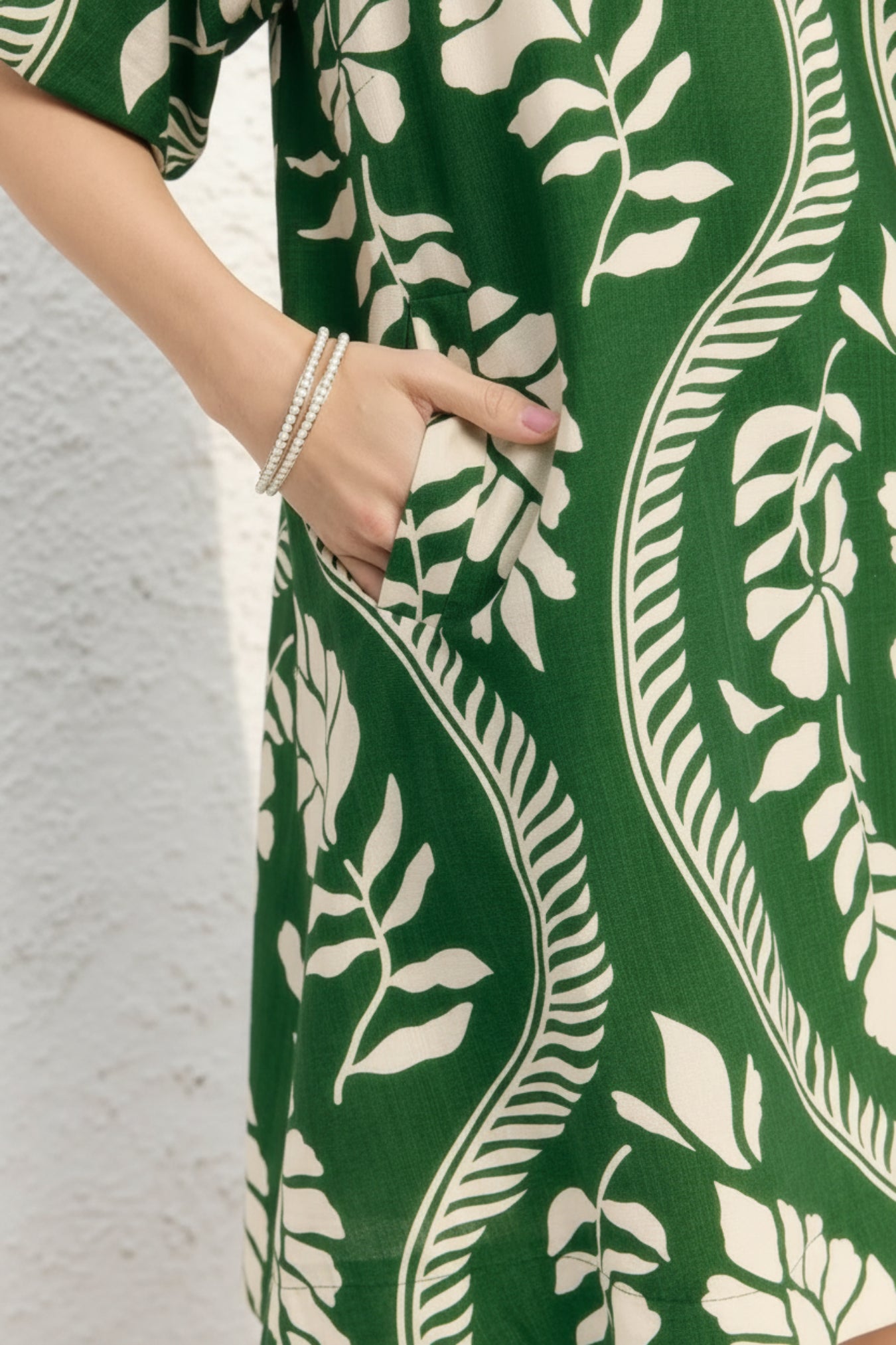 Green dress with white leaf pattern worn by a person