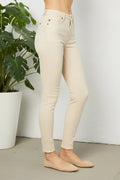 Beige jeans worn by a person on a white background