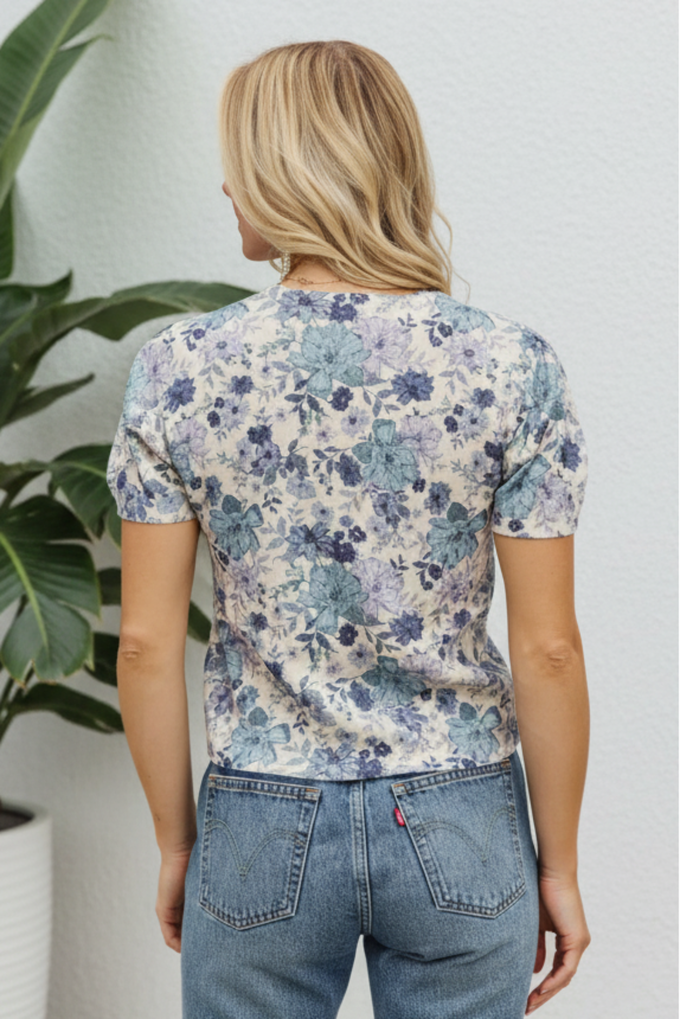 Woman wearing a floral blouse with a white background