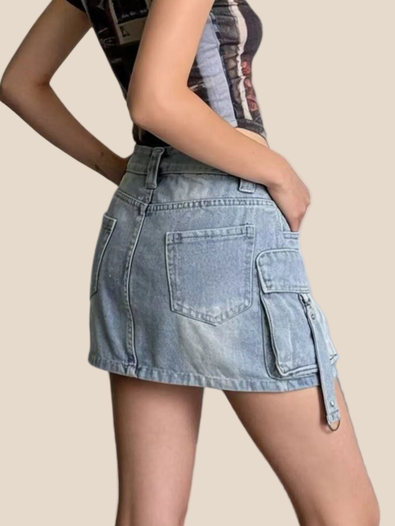 Denim skirt with cargo pockets worn by a person on a plain background