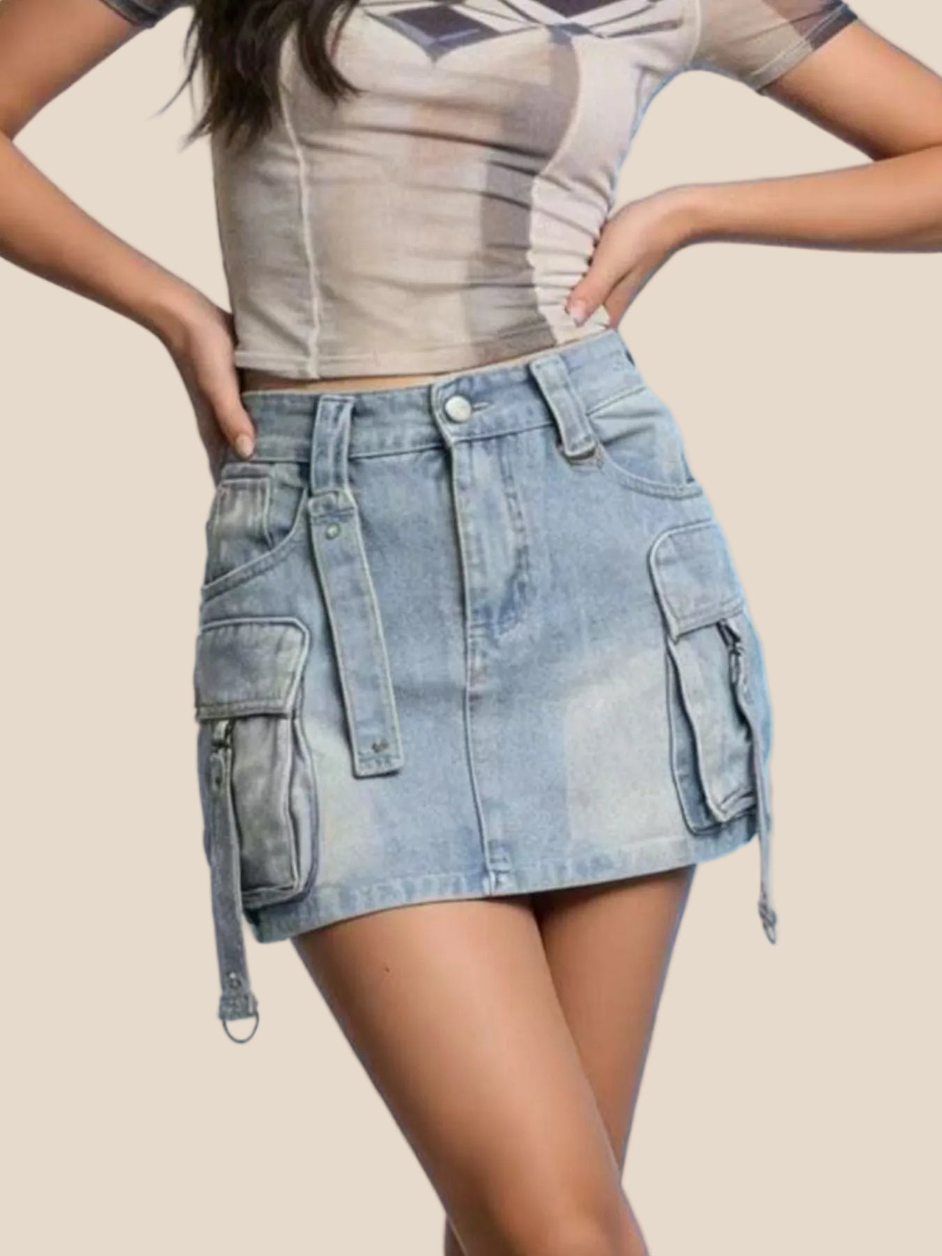 Person wearing a beige crop top and denim skirt