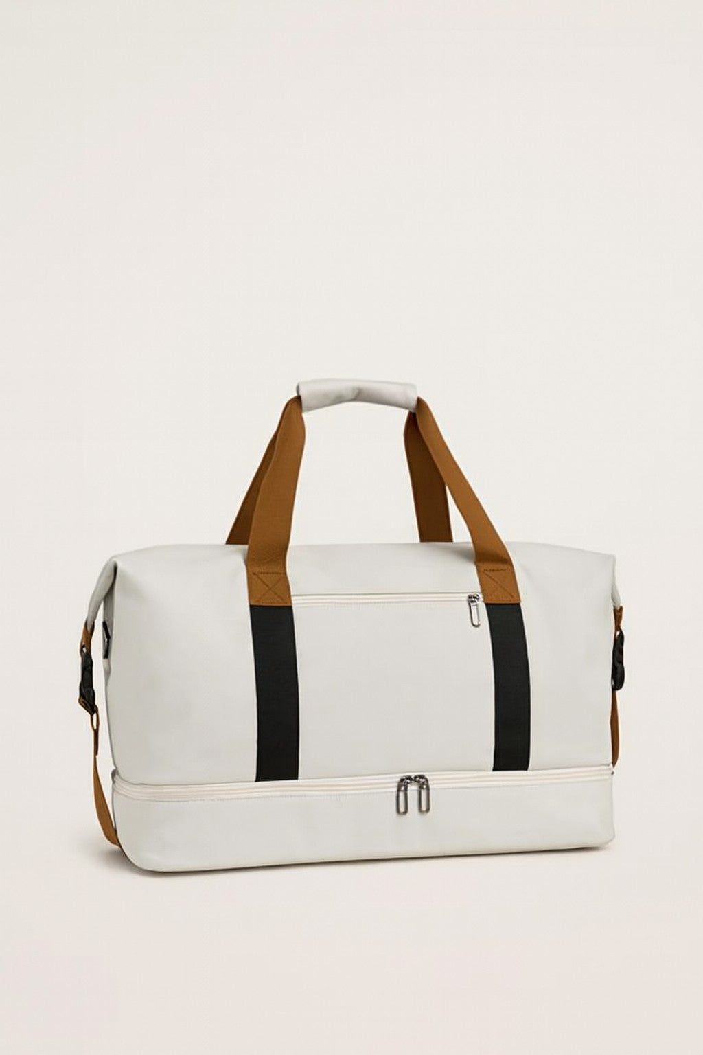 White duffel bag with tan handles, black stripes, top handle, side zippers