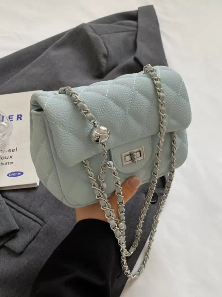 Blue quilted crossbody bag front view – gold chain strap