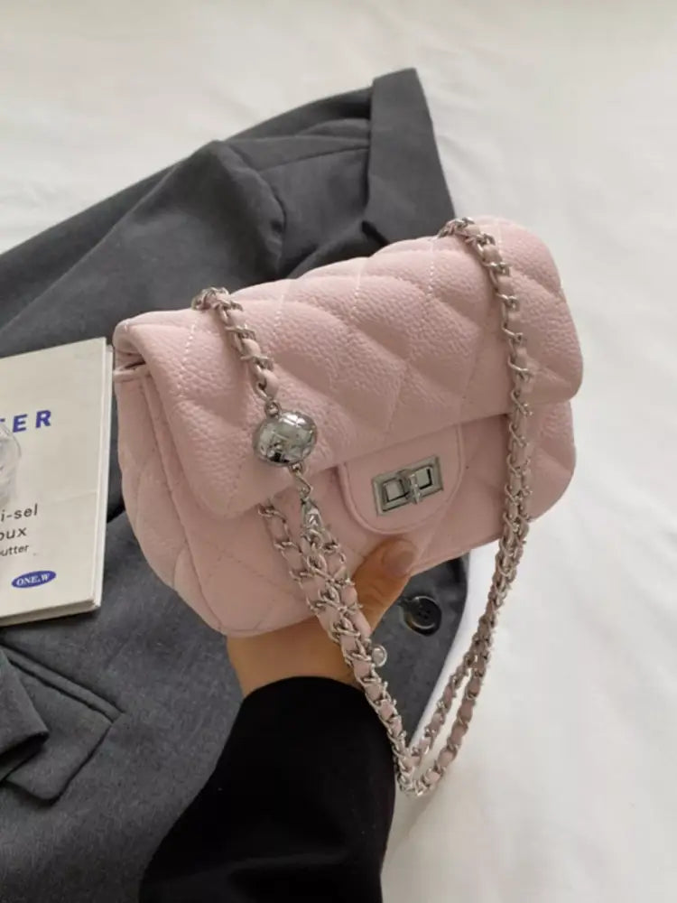 Pink quilted crossbody bag front view – gold chain strap