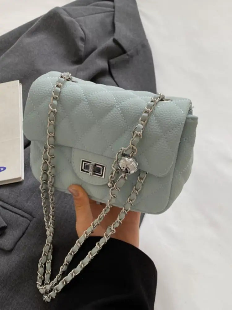 Blue quilted crossbody bag front view – gold chain strap